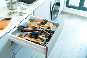 Messy kitchen utensils in a drawer 