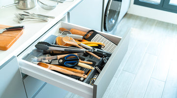 Messy kitchen utensils in a drawer 