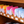 Load image into Gallery viewer, Colorful brochures on a wooden shelf with labels
